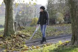 chica usando soplador de hojas en el exterior